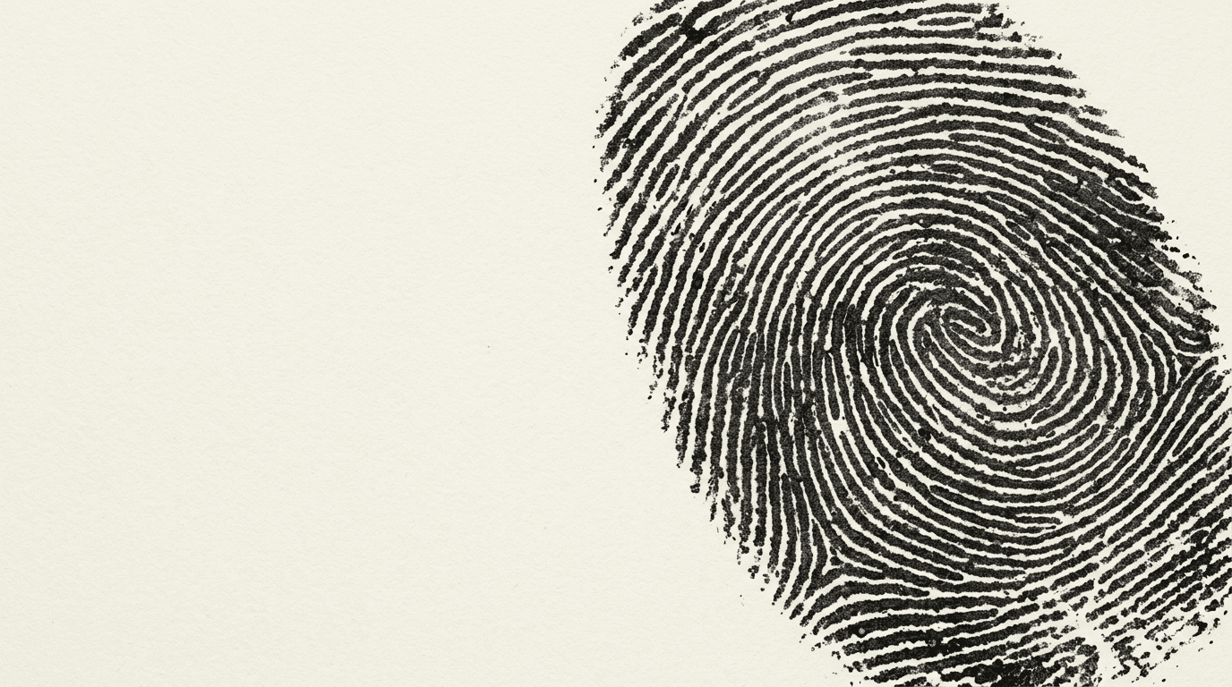 An oversized charcoal fingerprint impressed on warm, textured paper.